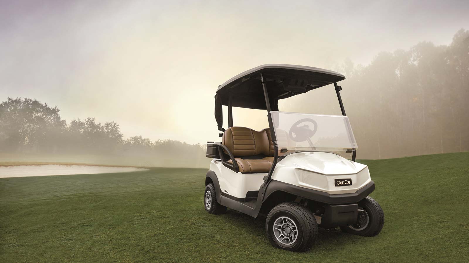 an electric golf cart, the club car tempo sits on golf course.