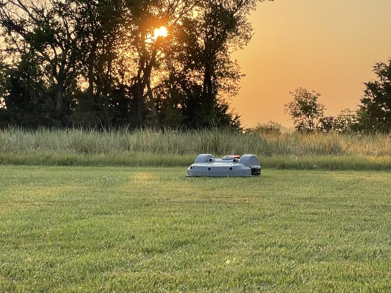 An Echo Robotics Turf Mower mows a strip along a green course.