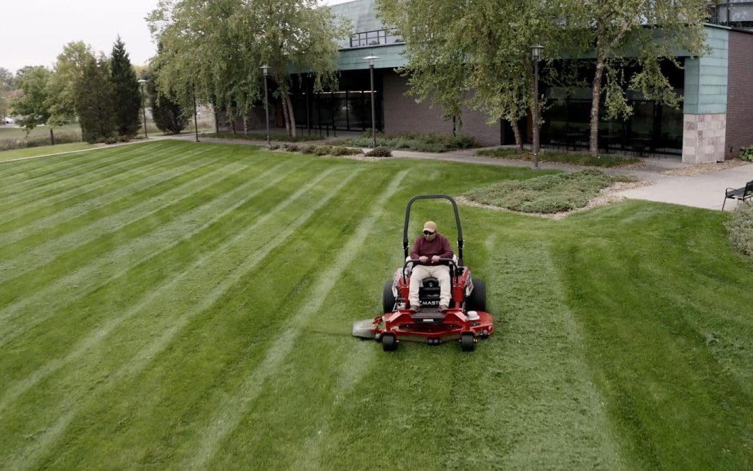 an electric riding lawn mower, the toro revolution z master on open lawn