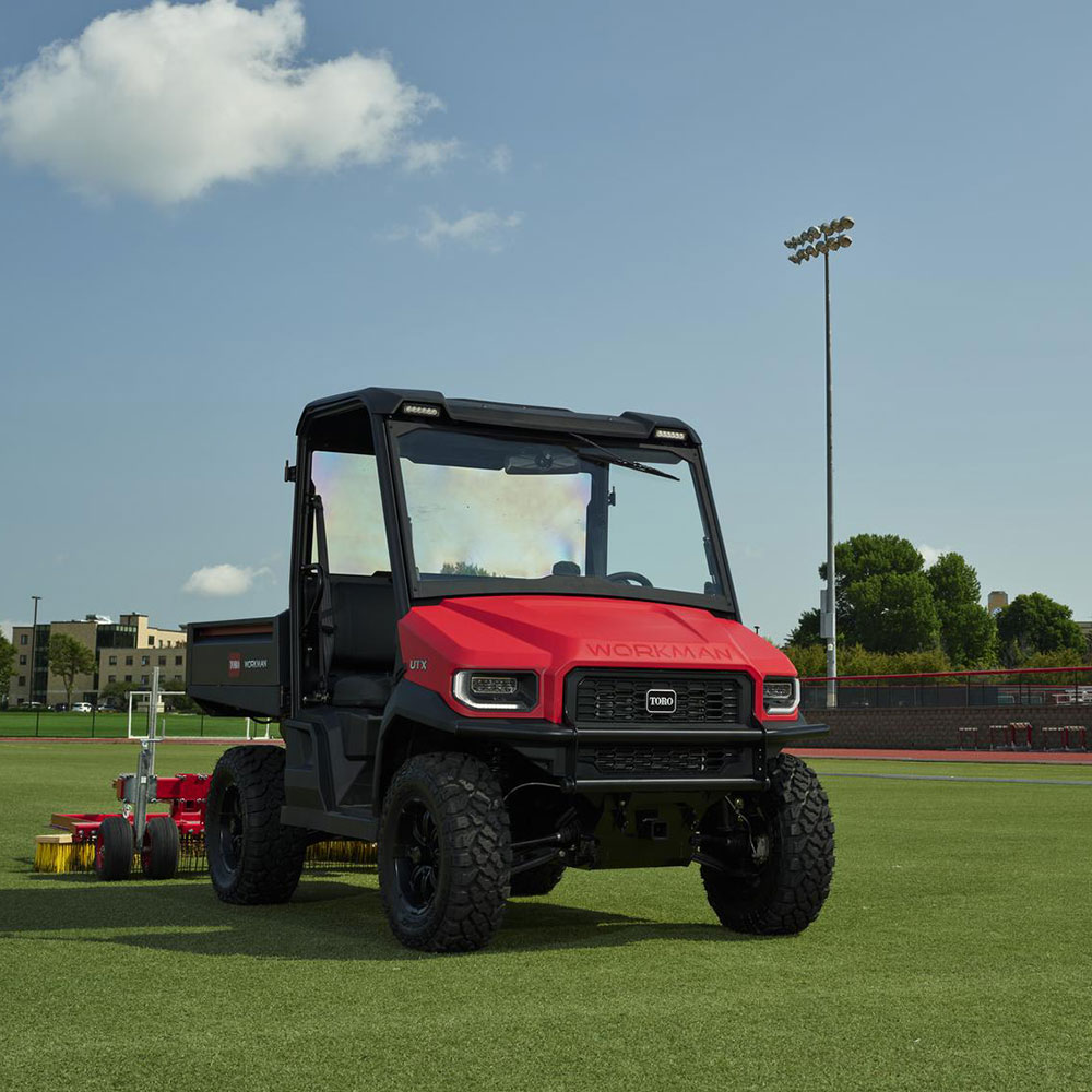 man using toro proline commercial-grade push mower in public lawn