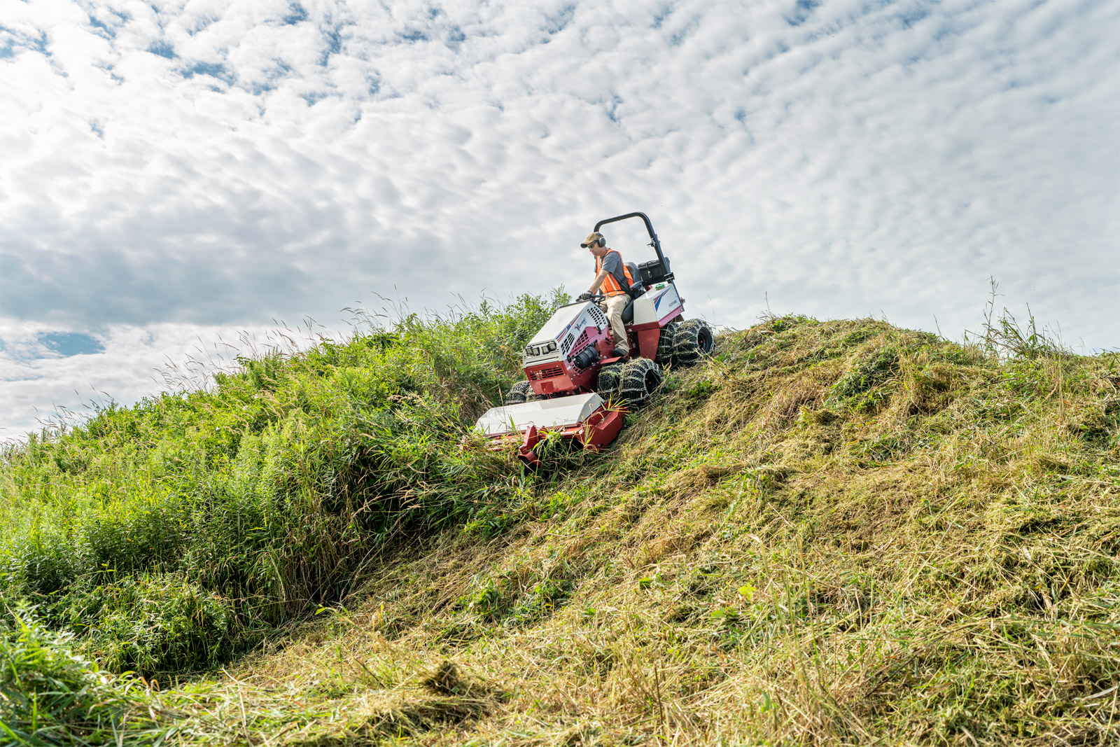 Man drives an articulation tractor through rough terrain