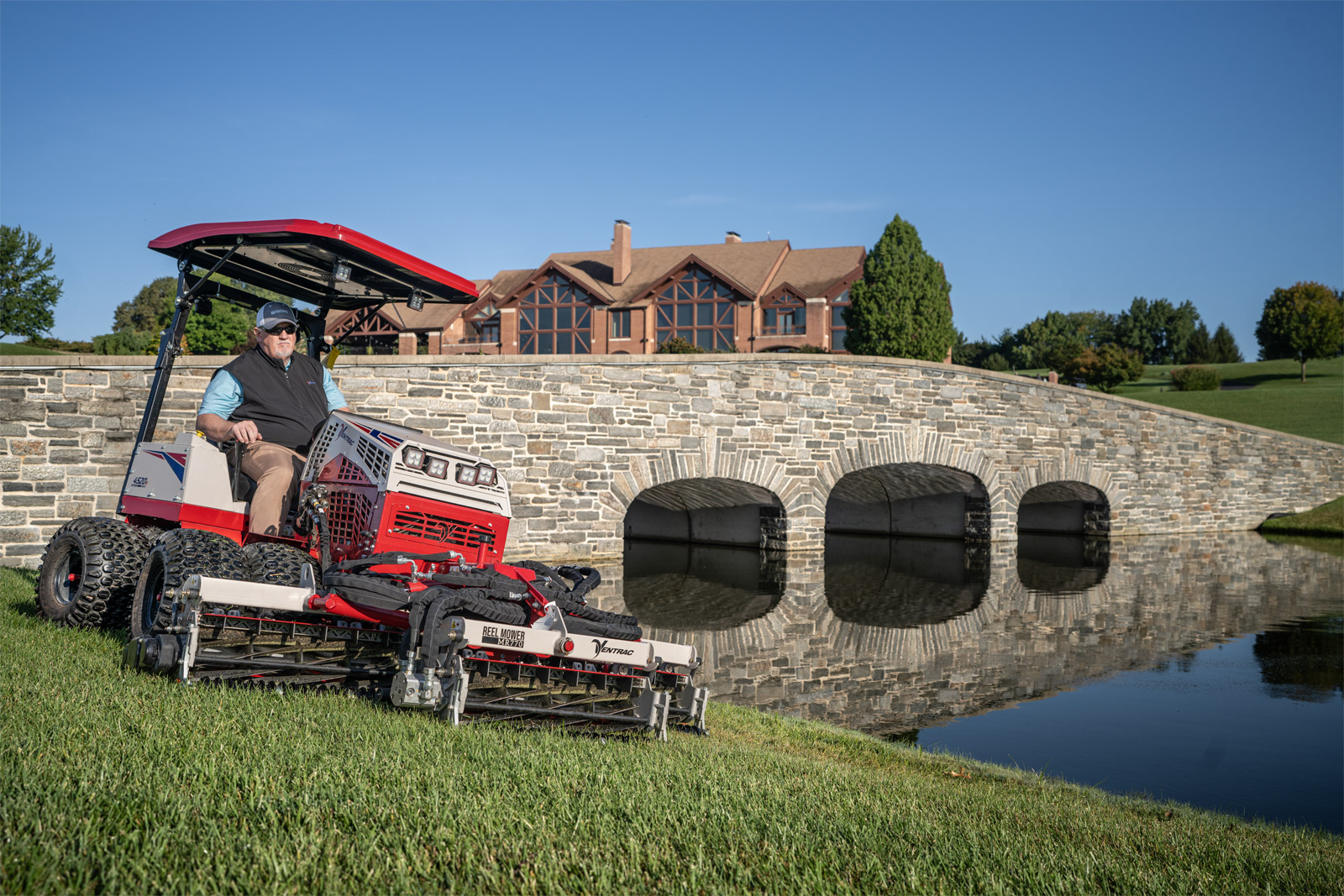 Man riding a Ventrac mower mowing his front lawn. 