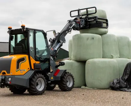 A GiANT Loader moving construction material.